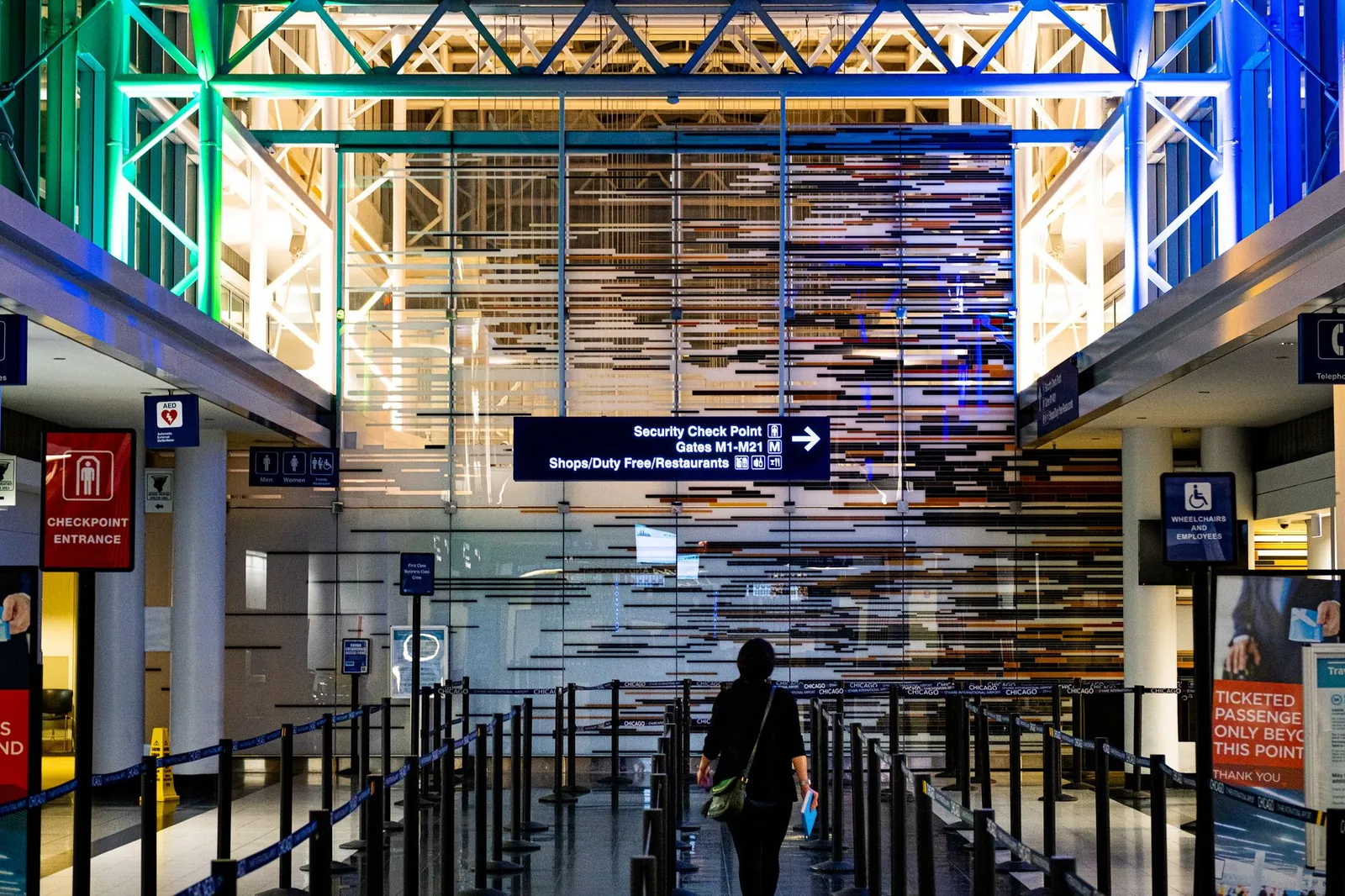 TSA security checkpoint with multiple open lanes and travelers queuing at a major US airport terminal