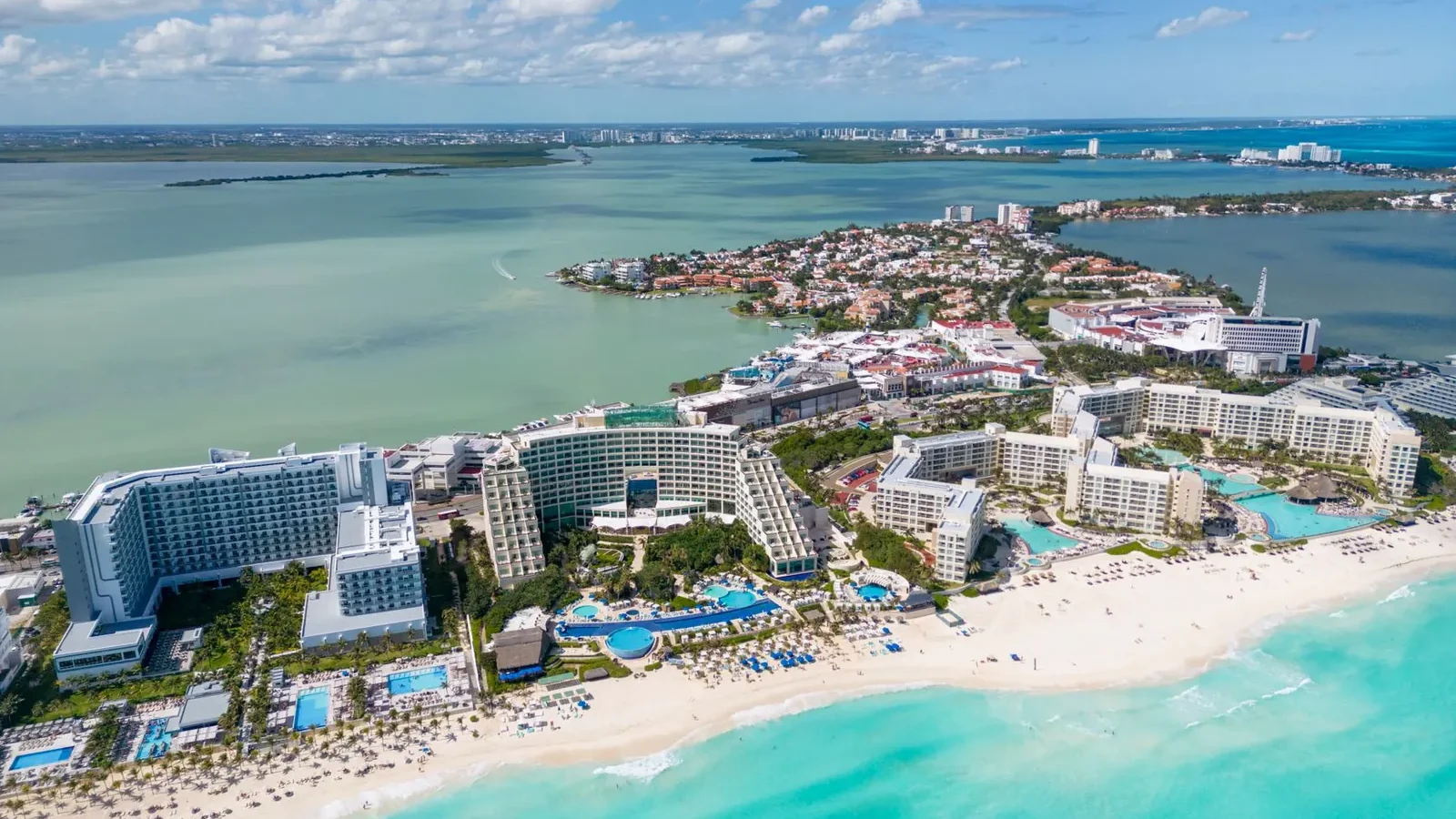 Overhead view of an all-inclusive resort showing pool, beach bars, and dining terraces