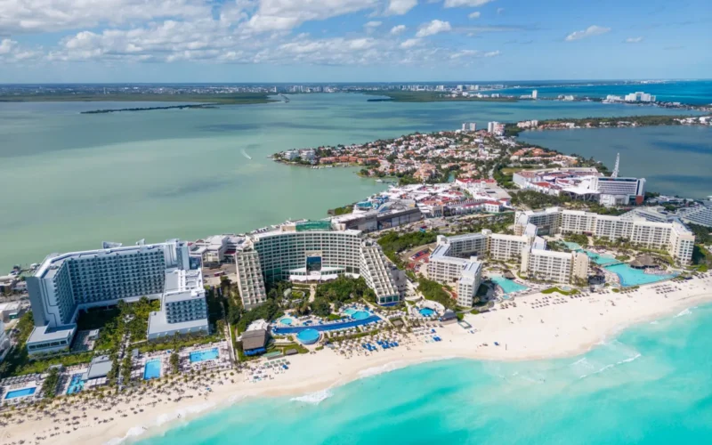 Overhead view of an all-inclusive resort showing pool, beach bars, and dining terraces