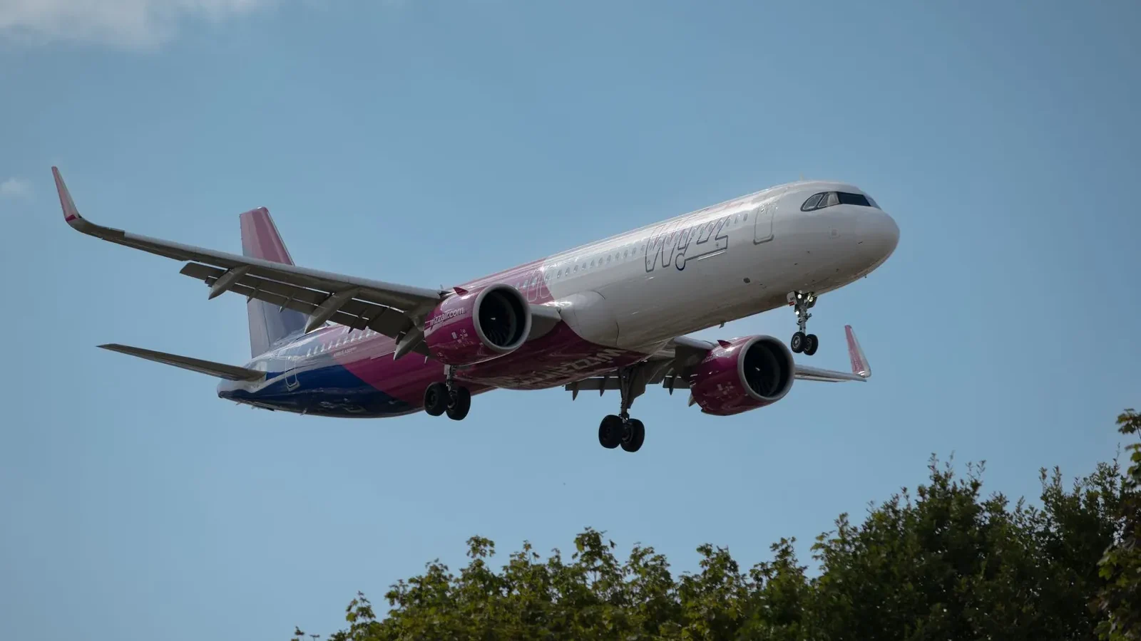 Ryanair, Wizz Air, and easyJet boarding passes side by side showing base fares and itemized add-on costs for the same London–Barcelona route