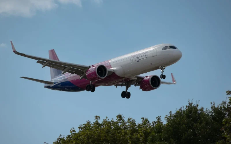 Ryanair, Wizz Air, and easyJet boarding passes side by side showing base fares and itemized add-on costs for the same London–Barcelona route