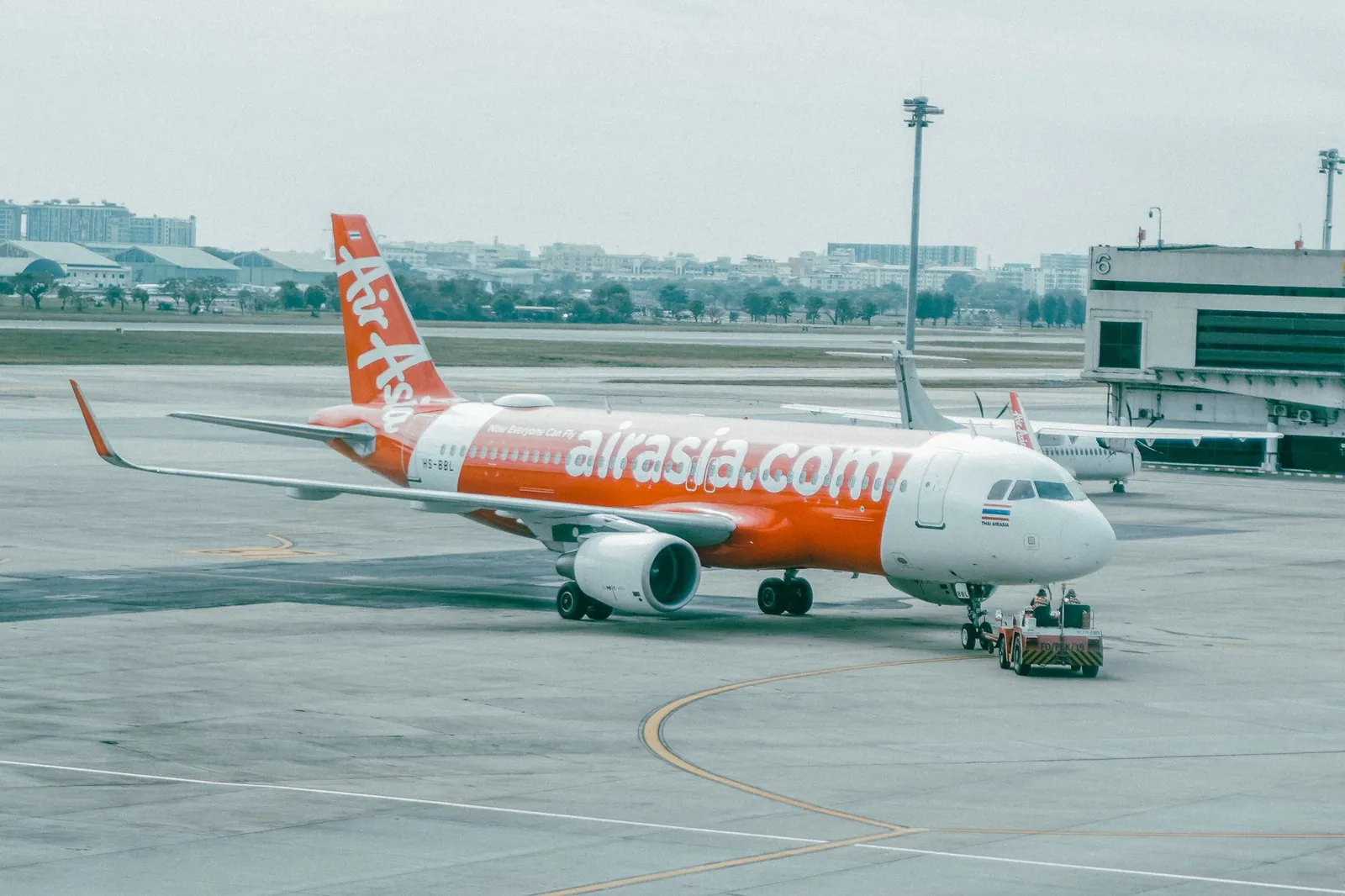Ryanair, Wizz Air, and easyJet boarding passes side by side showing base fares and itemized add-on costs for the same London–Barcelona route