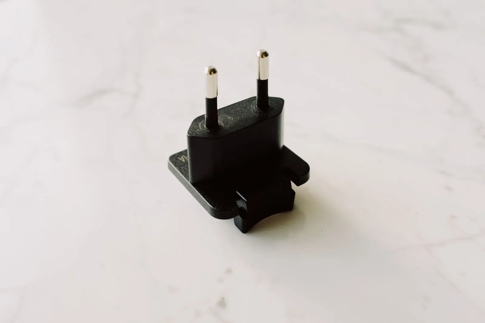 Anker PowerExpand adapter seated in a European Type C outlet with two USB cables connected and no visible gap at the plug face