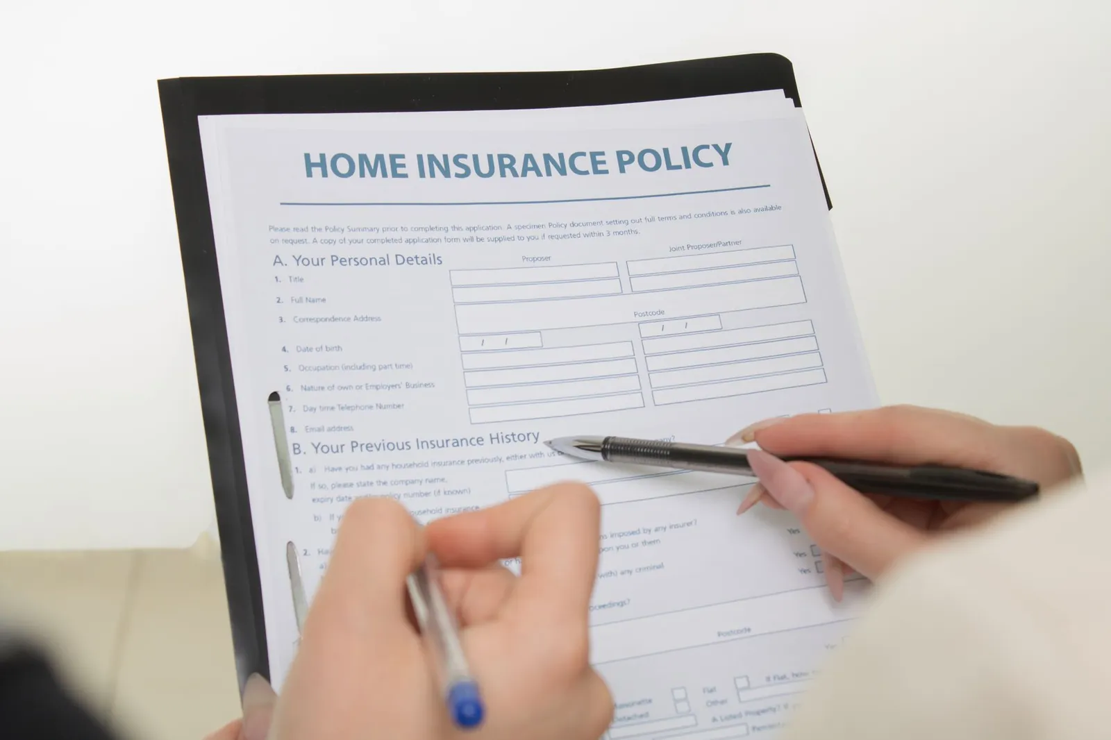 Travel insurance policy document open on a table with a pen and passport nearby
