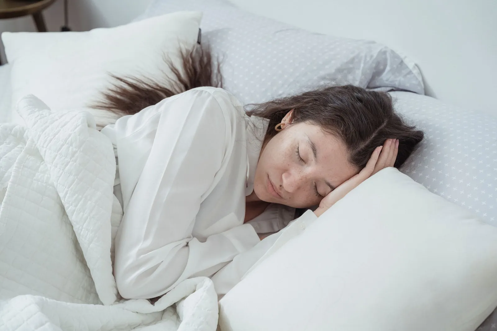Lumbar support pillow placed behind lower back in economy airplane seat