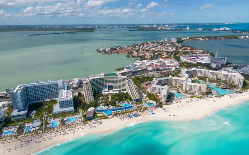 Aerial view of Cancun's Hotel Zone showing the curved beach and high-rise resorts lining the coast