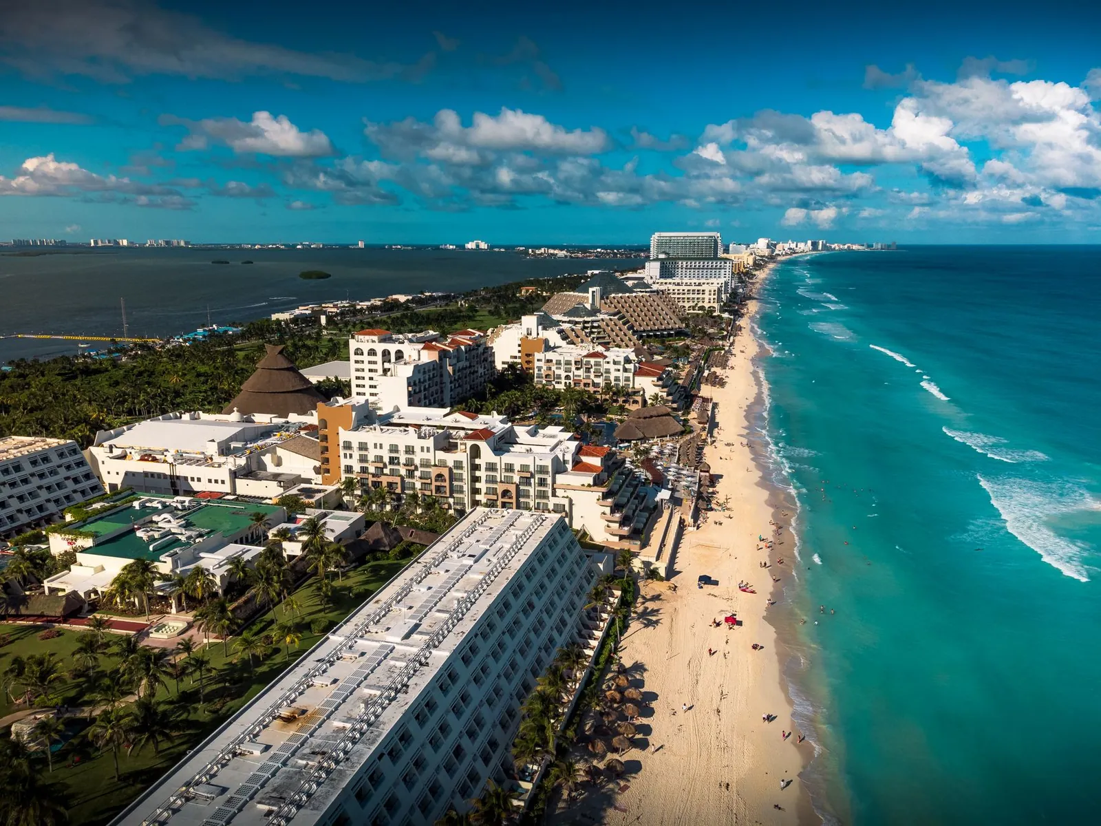 Aerial view of Cancun's Hotel Zone showing the curved beach and high-rise resorts lining the coast