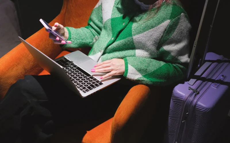 Passport, laptop, and handwritten visa notes on a wooden desk—tools for planning a digital nomad visa application