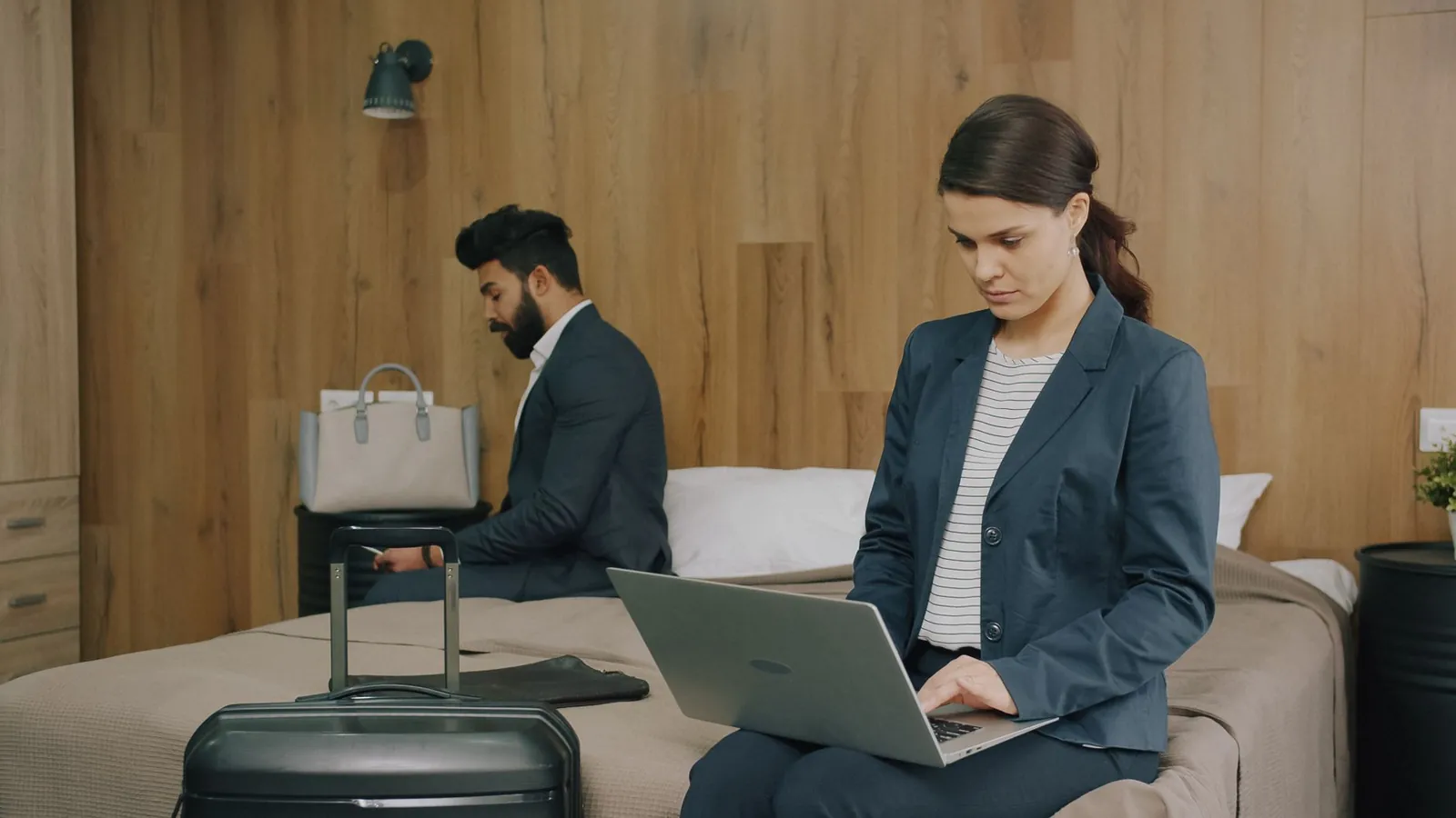 Laptop screen showing four hotel booking sites open in separate tabs with price differences of $30–$80 for the same room