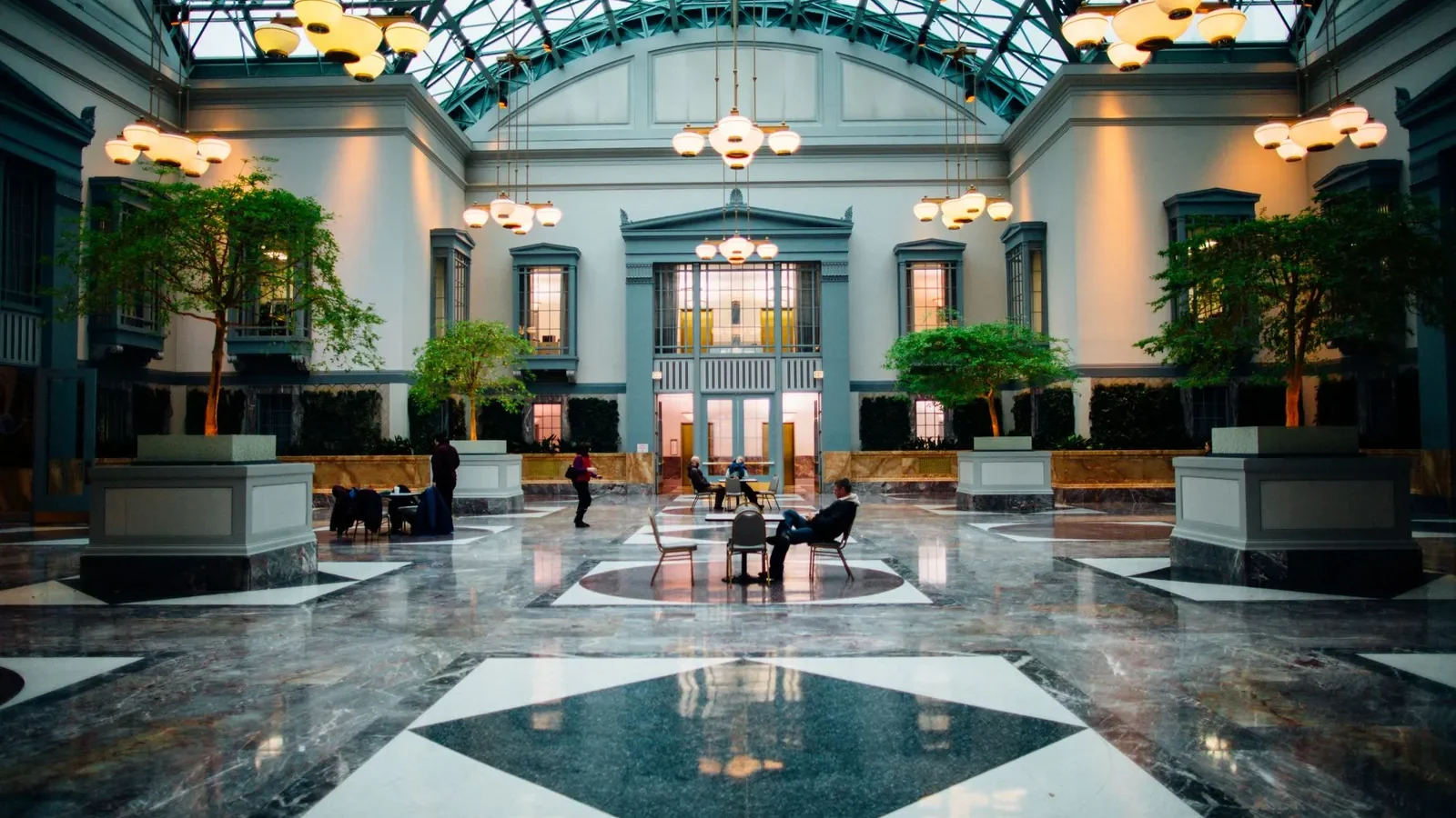 High-ceilinged lobby of a newly opened European luxury hotel with warm lighting and contemporary furnishings