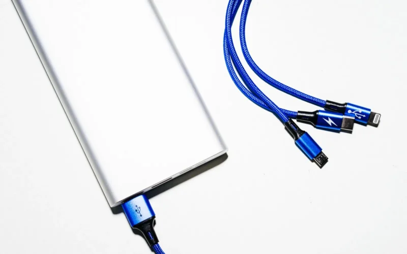 Five portable chargers of different sizes arranged by capacity, from small 5000mAh to large 30000mAh units, showing relative weight and pocket fit