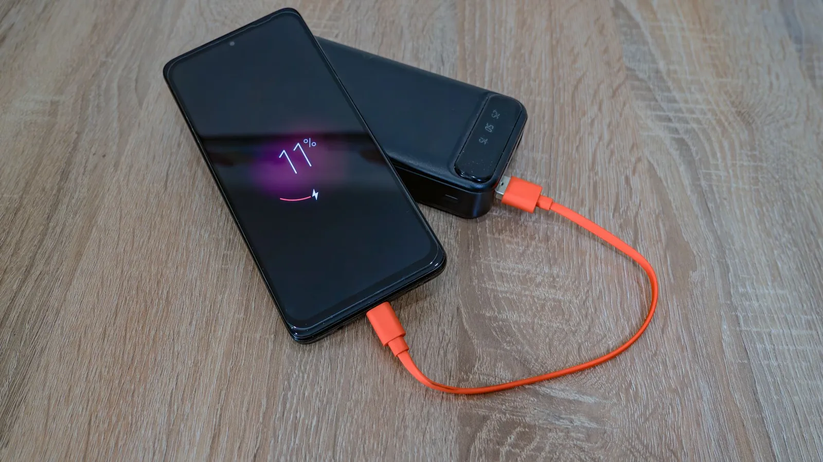 Five portable chargers of different sizes arranged by capacity, from small 5000mAh to large 30000mAh units, showing relative weight and pocket fit