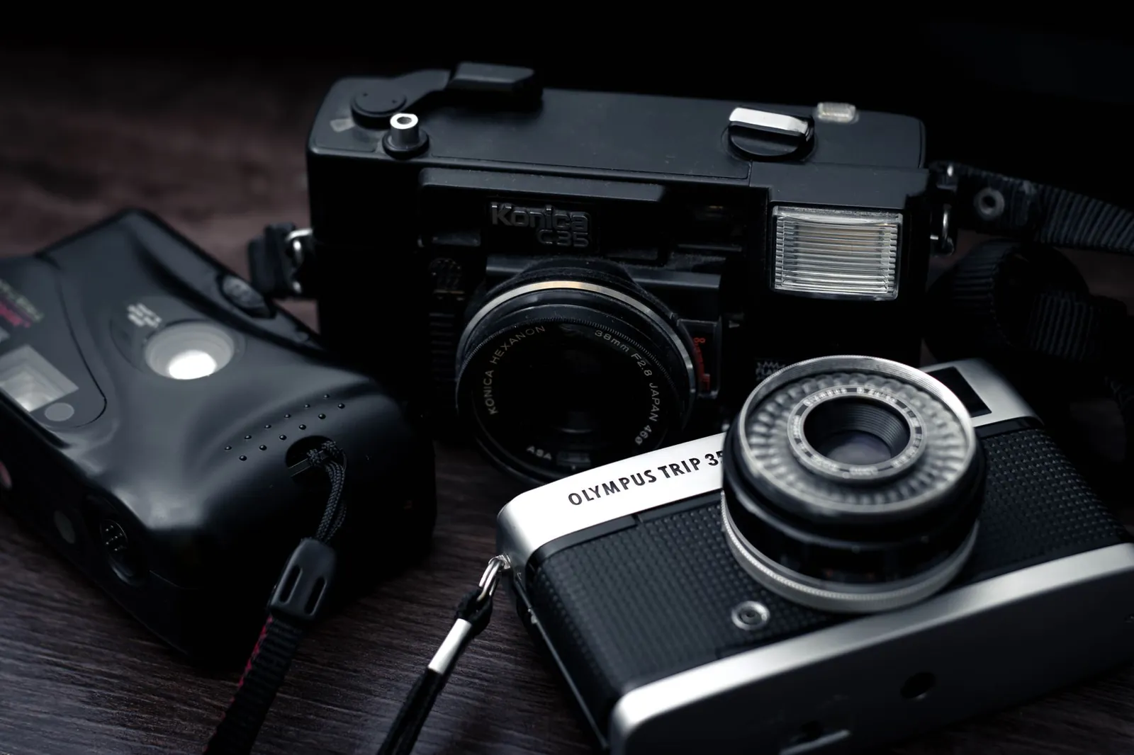 Mirrorless camera body with 24-70mm zoom lens resting on a travel backpack